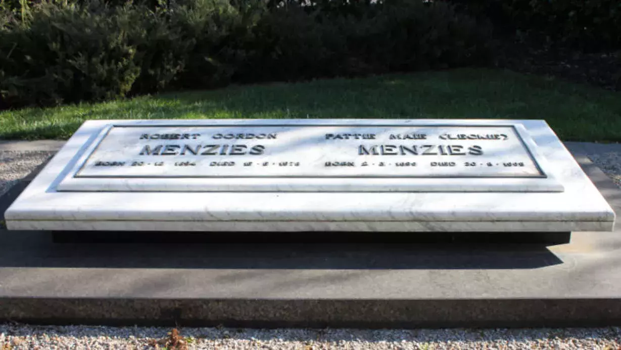 A stone plaque in a cemetery that reads 'Menzies'. 