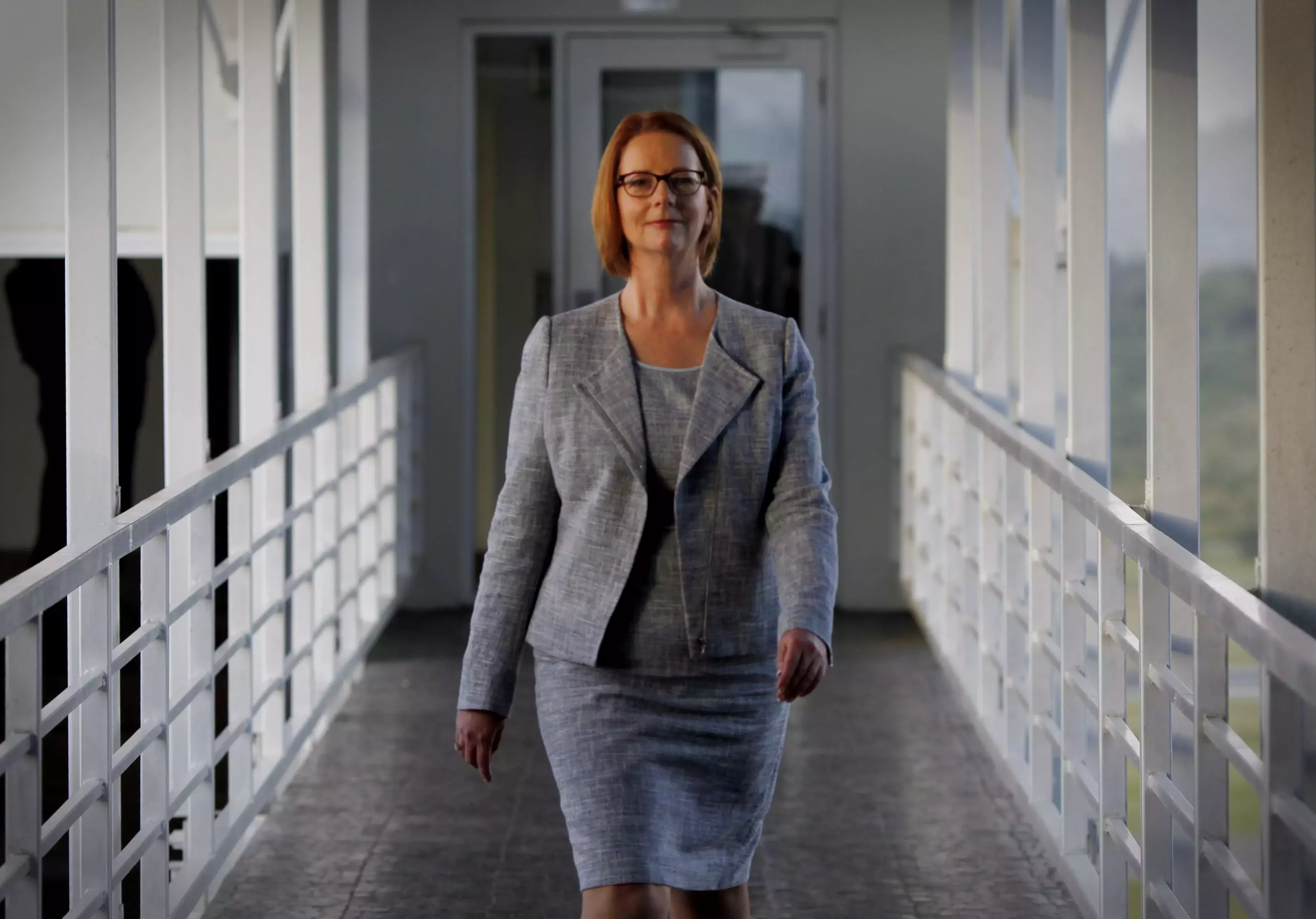Julia Gillard walking down a hallway. 