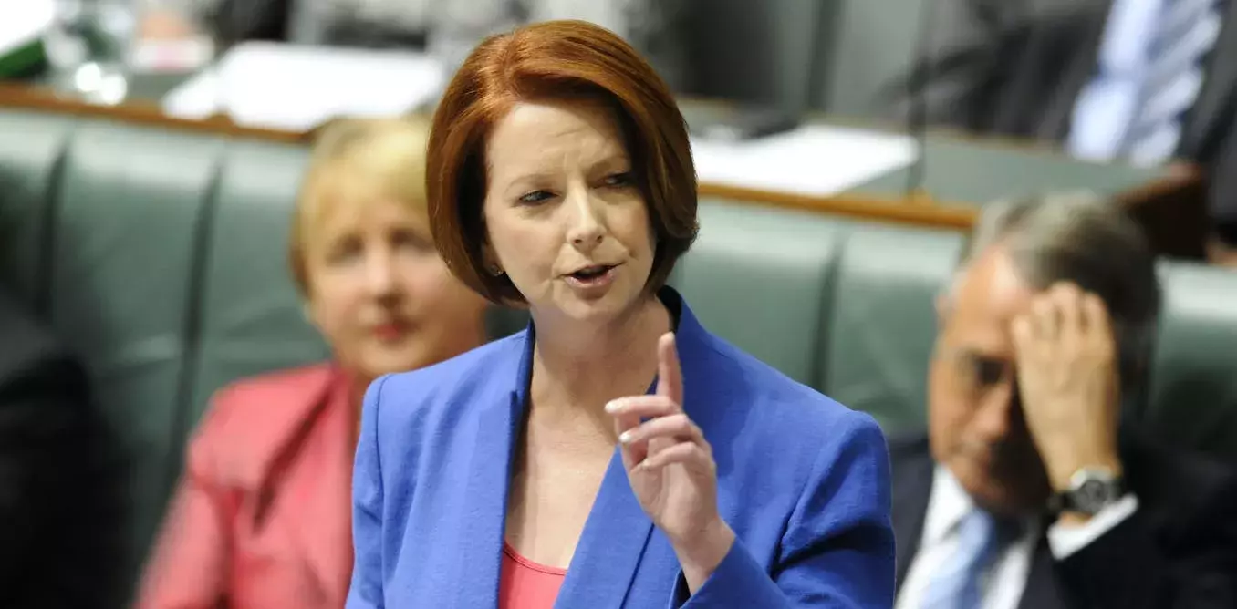 Julia Gillard mid sentence with her hand raised as she gives her speech in parliament. 