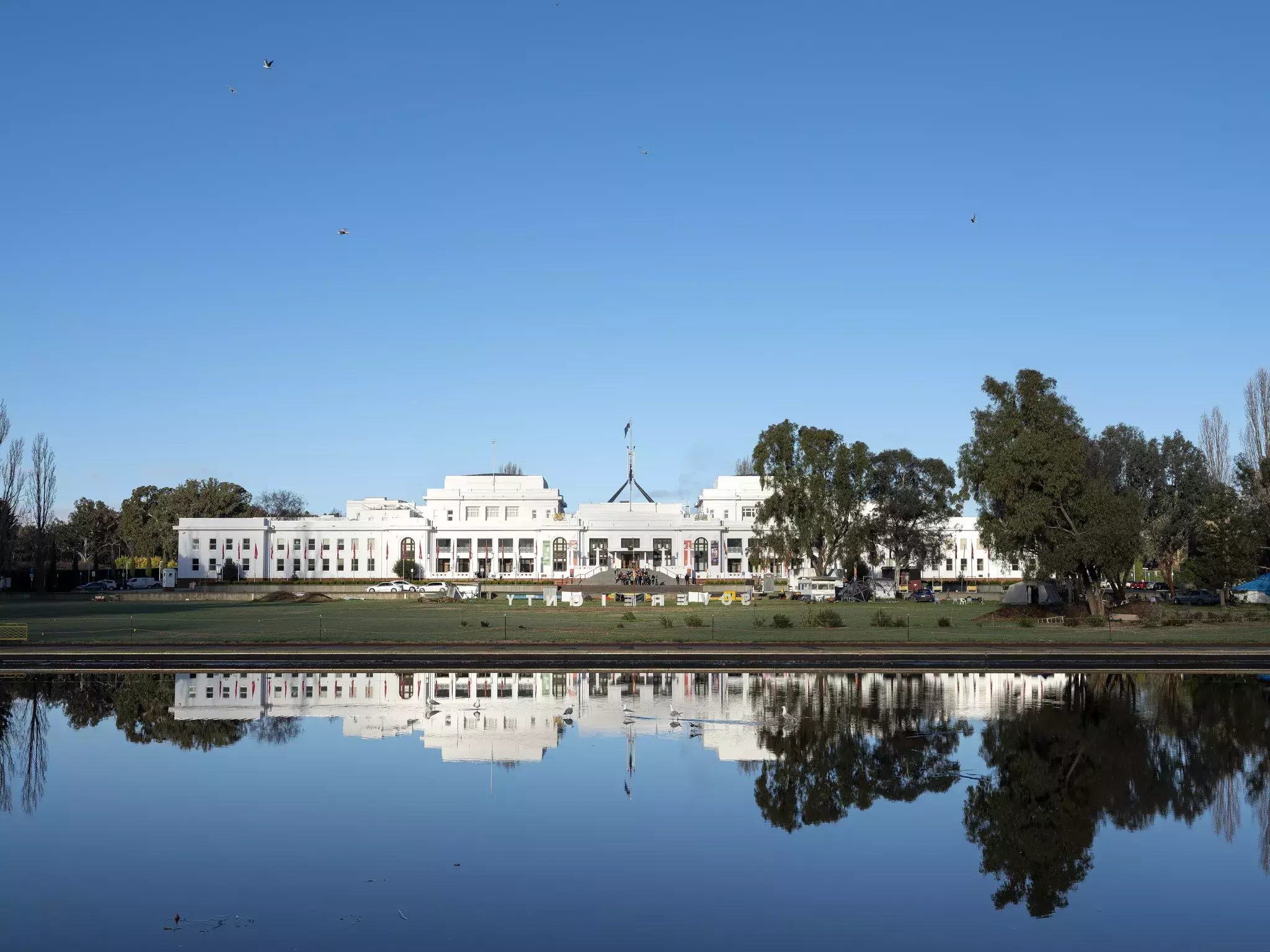 Old Parliament House in the distance with a lake in front.  