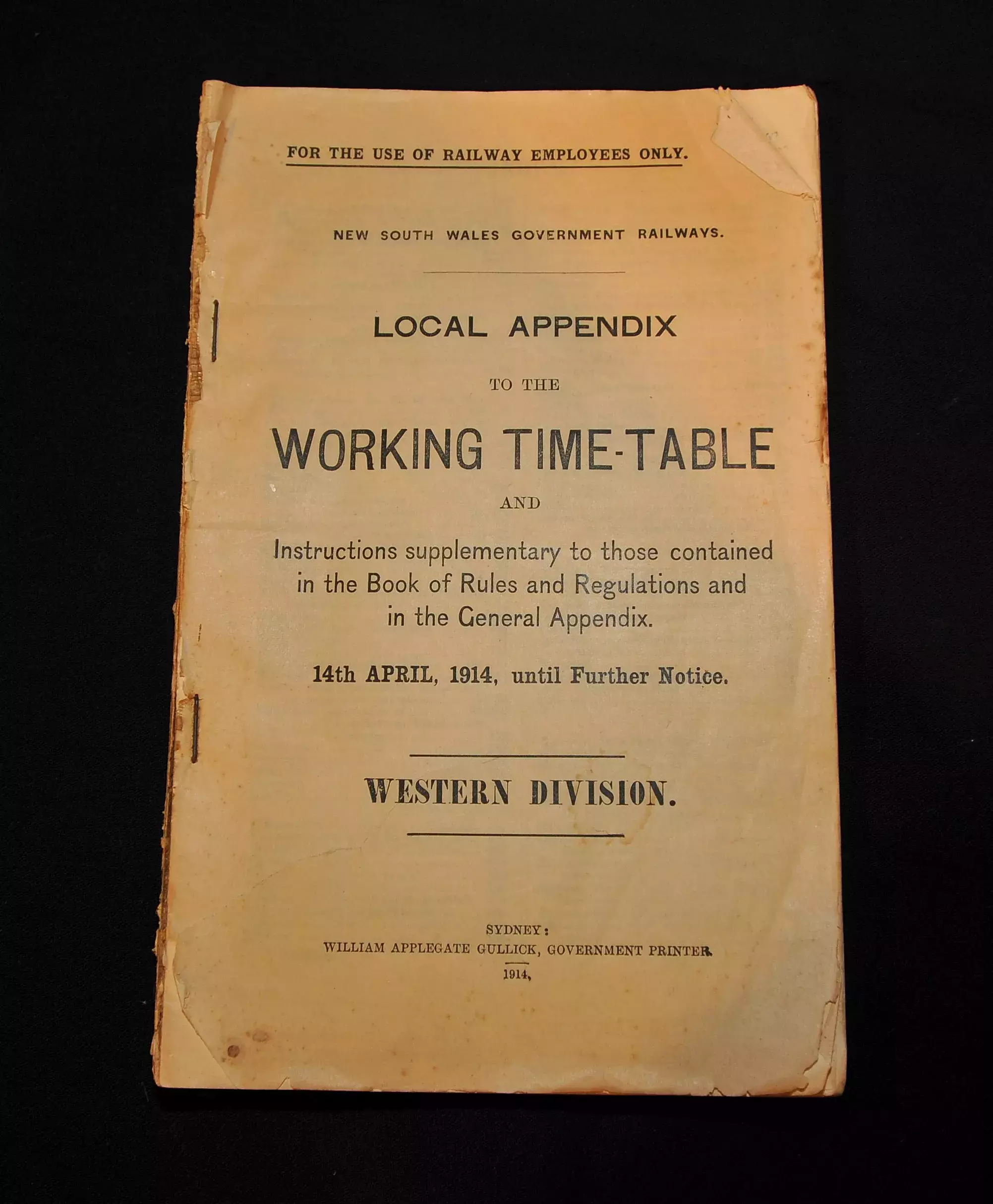 A brown paper old booklet that says 'Working Timetable' 