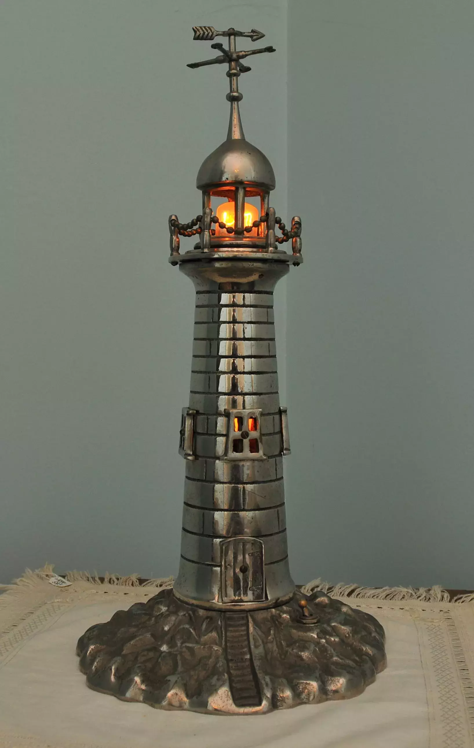 A metallic model lighthouse 